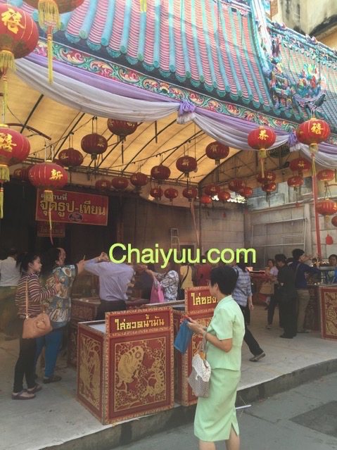 ผู้คนต่อคิวบริเวณจุดใส่ซองทำบุญภายในวัดจีน